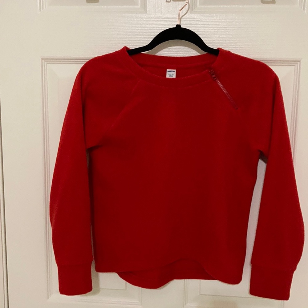 A red sweater with a cute zipper at the top.